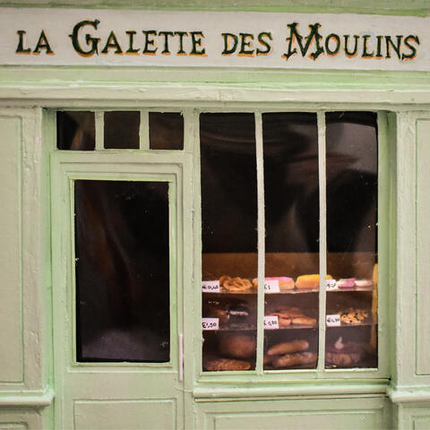 Patisserie goods seen through shop window.