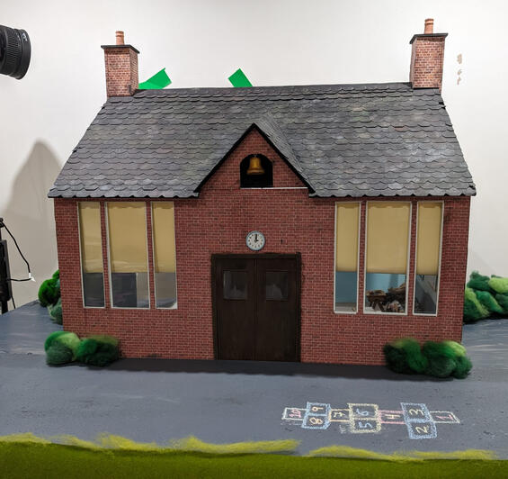 full school house exterior set with moving clay bell.